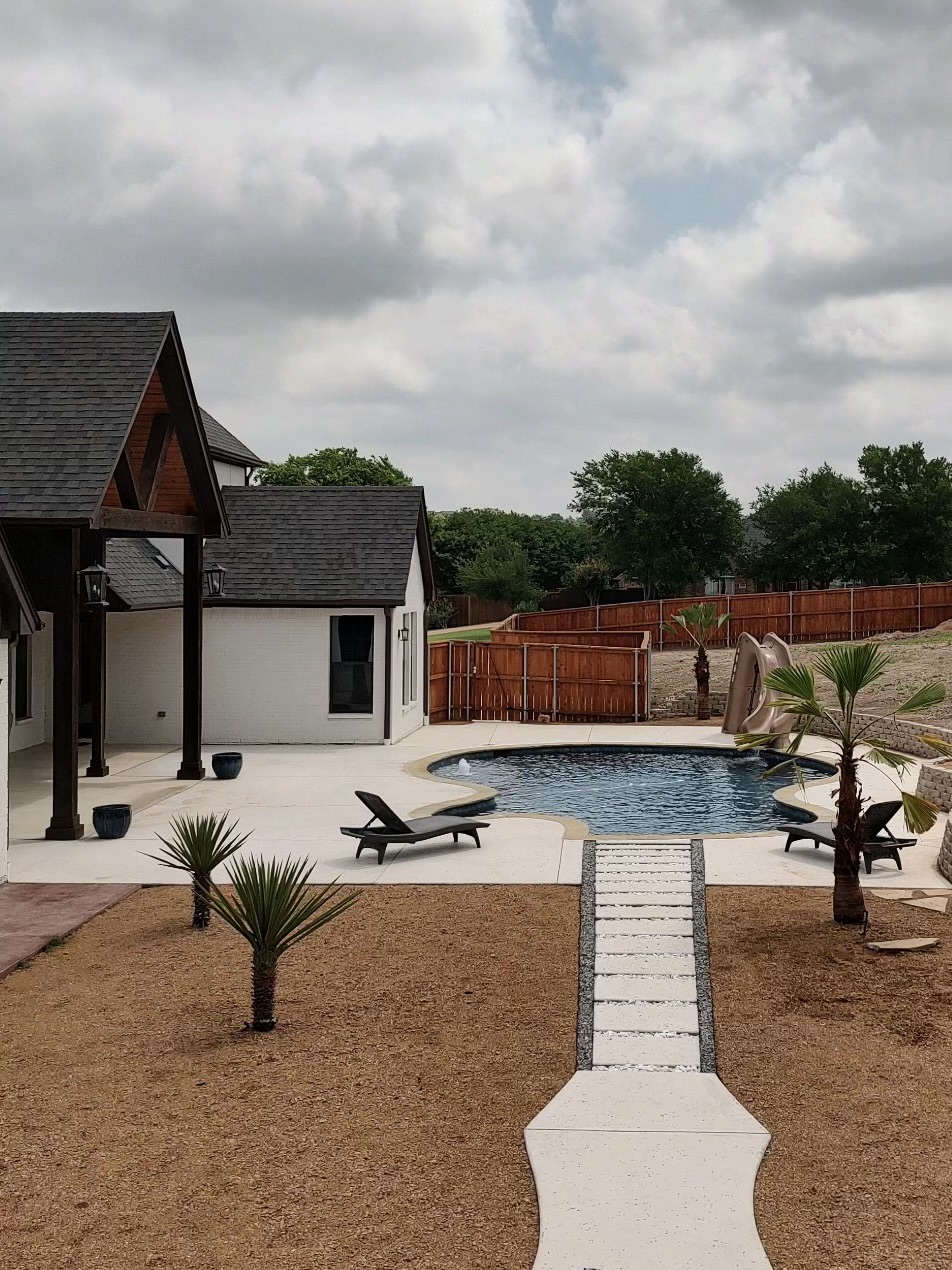 Finished Texas Traditions Outdoors pool and patio project with water feature.